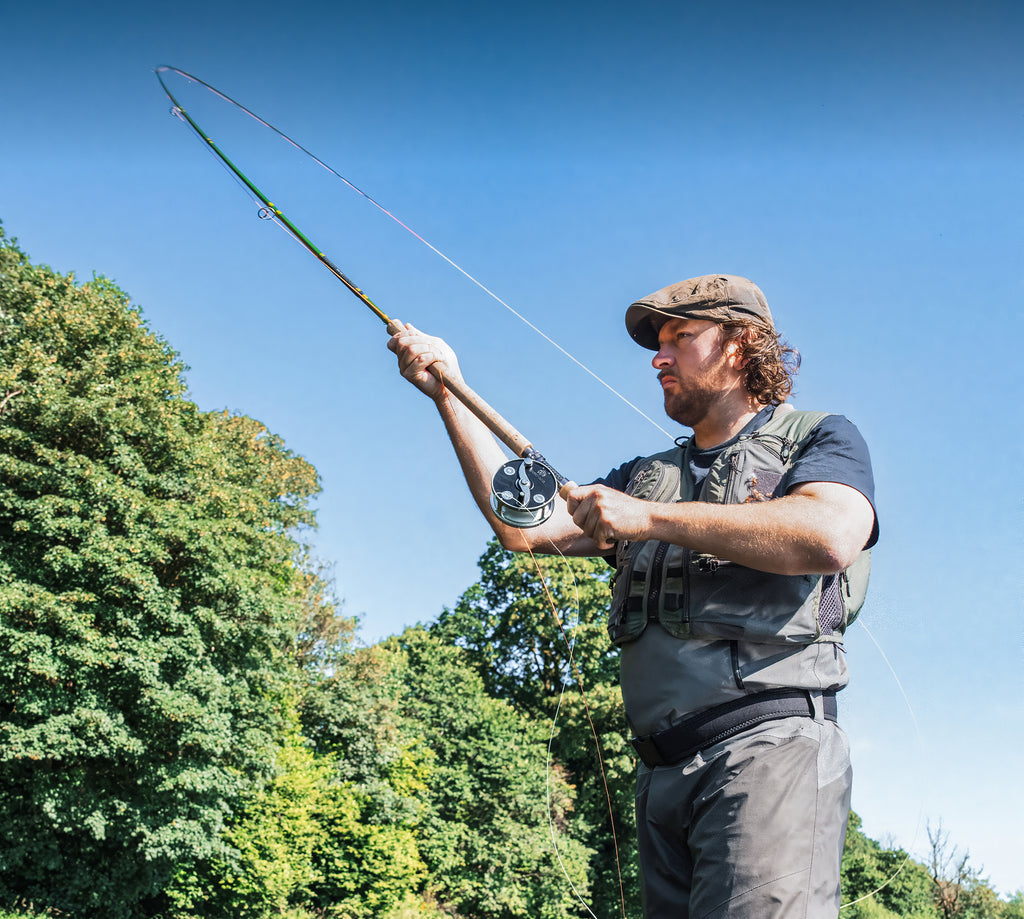 Angler fly fishing with a Hardy Cascapedia fly reel and two-handed fly rod.