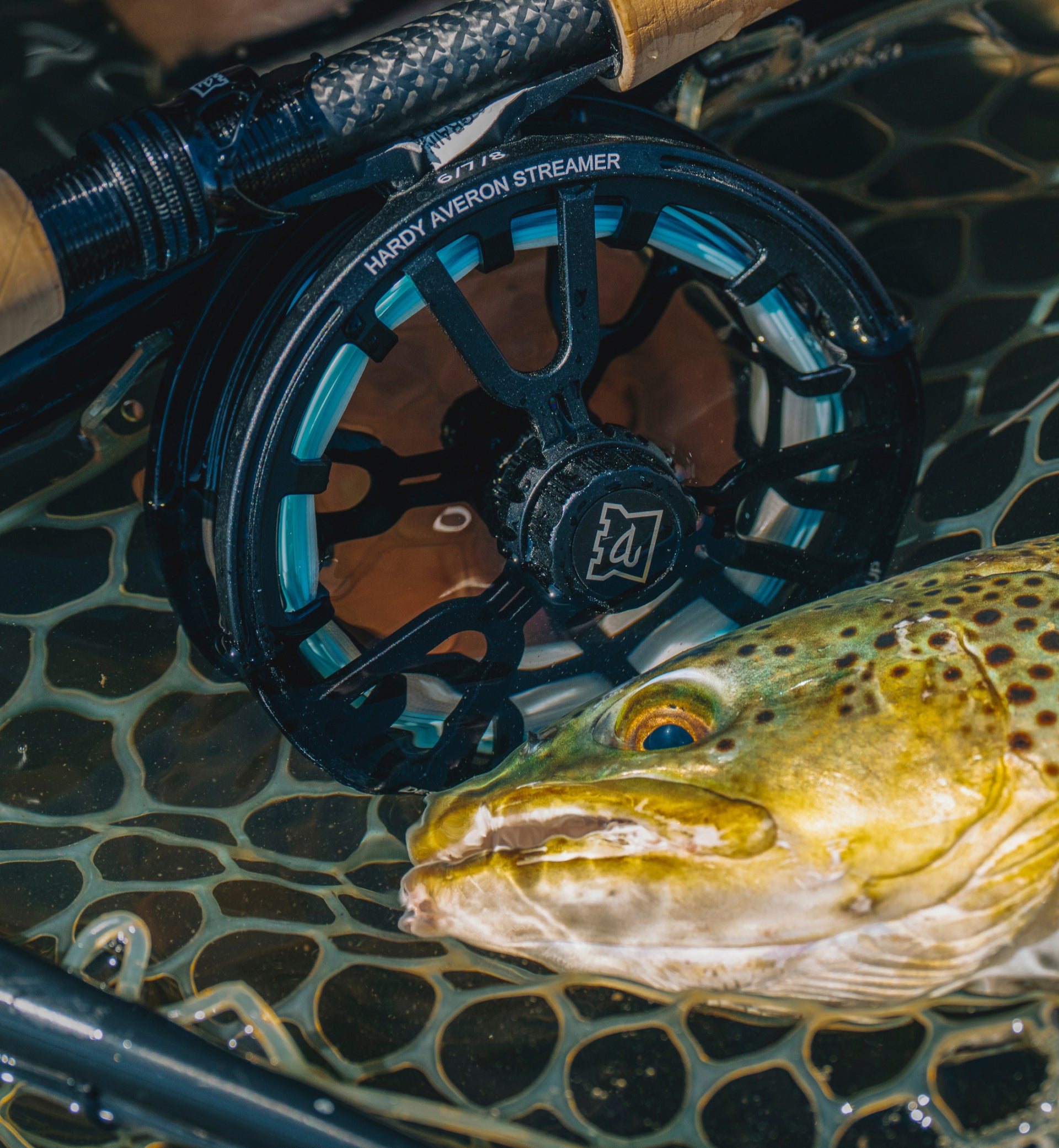 Fly fishing reel with a fish on a textured surface